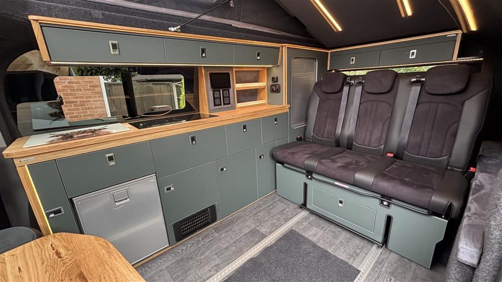 The galley kitchen and the three-seat belted bench